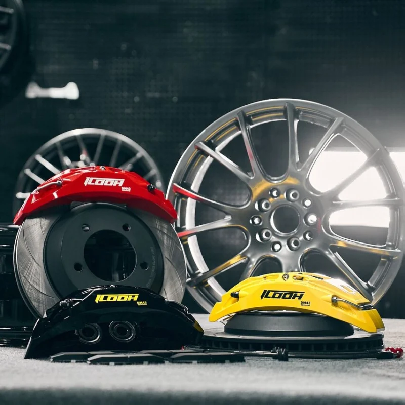 Red, yellow, and black performance brake calipers with wheel