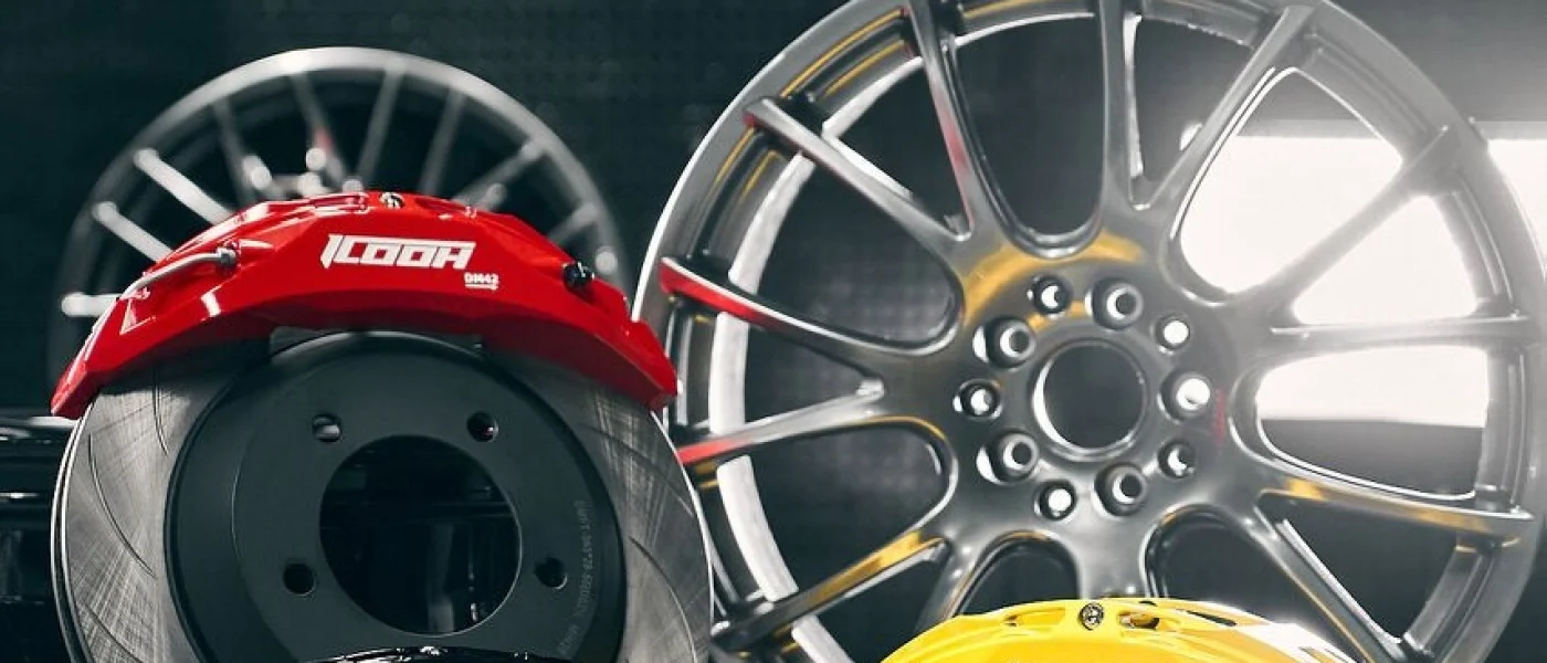 Red, yellow, and black performance brake calipers with wheel